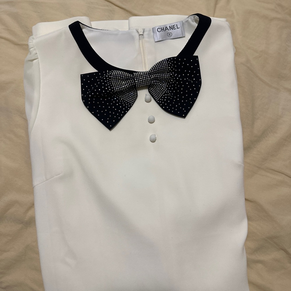 CHANEL Ivory Top with Black Embellished Bow